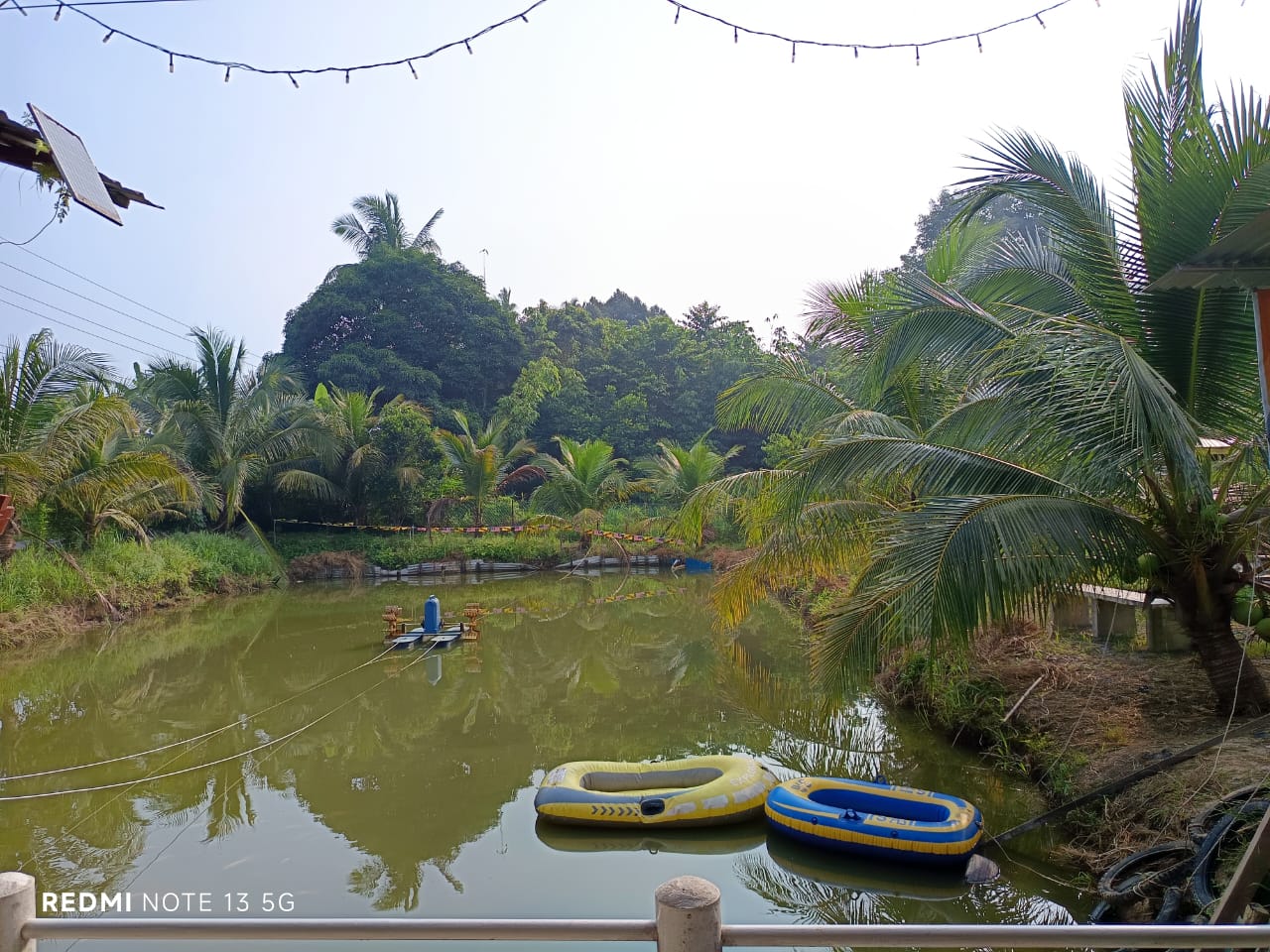 Inflatable boats floating on the scenic pond at CMN Fish Farm