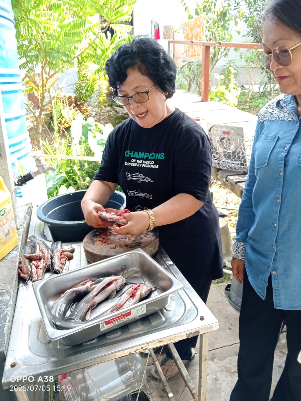 Clarissa preparing siap siang cleaned catfish at CMN Fish Farm
